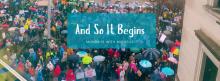 Aerial photo of protesters with a blue box and the words "And So It Begins" written in white