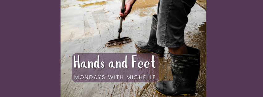 Image of a person wearing work boots sweeping floor